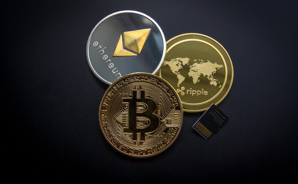 ripple-etehereum-and-bitcoin-and-micro-sdhc-card-844124 A striking image of Bitcoin, Ethereum, and Ripple coins illustrating modern digital currency.